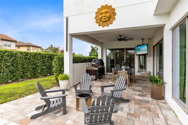 view of patio / terrace featuring ceiling fan and a grill