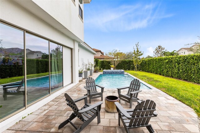 view of swimming pool featuring pool water feature and a patio