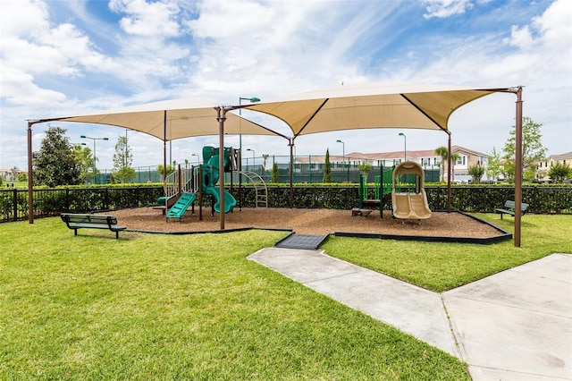 view of jungle gym featuring a lawn