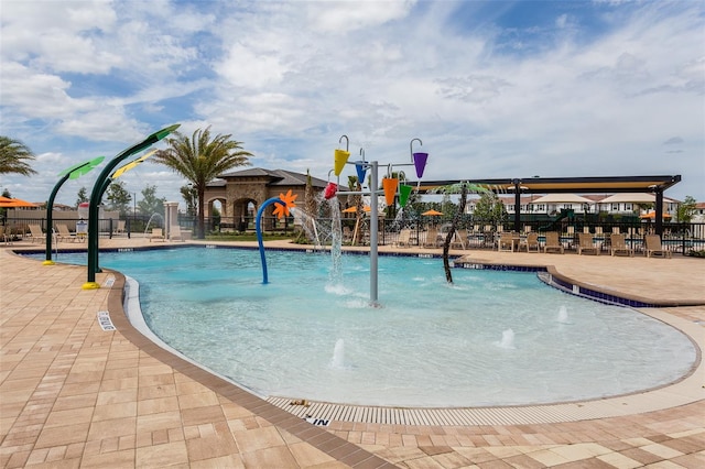 view of swimming pool featuring pool water feature and a patio