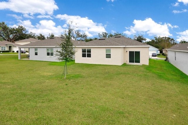 rear view of house with a yard