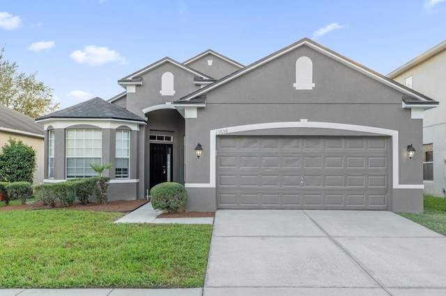 view of front facade with a front yard and a garage