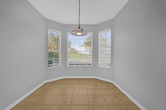 unfurnished dining area featuring a wealth of natural light and light tile patterned flooring