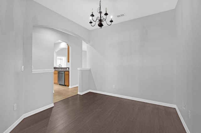 unfurnished dining area with hardwood / wood-style flooring and a chandelier