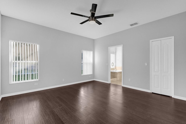 spare room with ceiling fan and dark hardwood / wood-style flooring