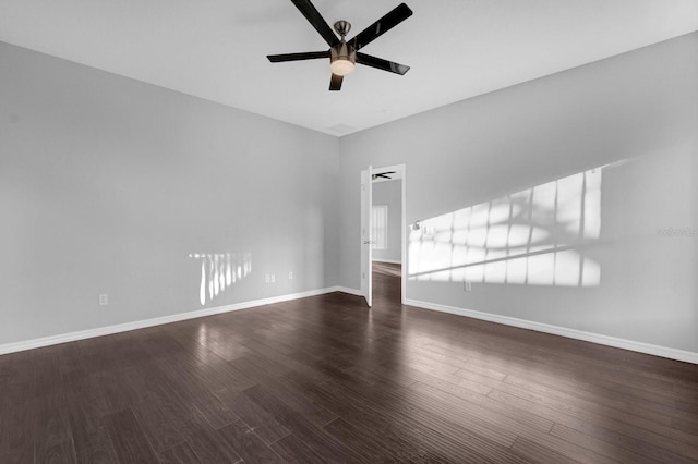 empty room with ceiling fan and dark hardwood / wood-style floors