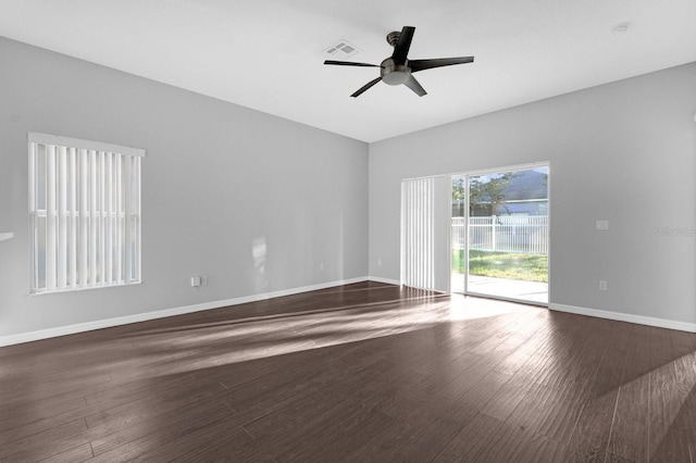 unfurnished room with dark hardwood / wood-style floors and ceiling fan