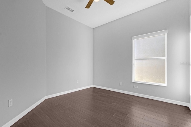 unfurnished room with dark hardwood / wood-style floors and ceiling fan