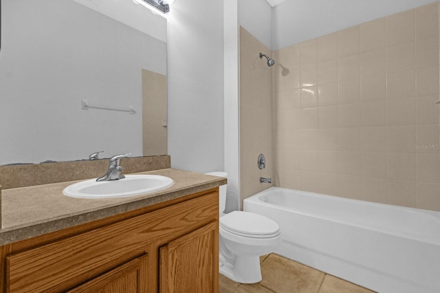 full bathroom featuring toilet, vanity, tile patterned floors, and tiled shower / bath