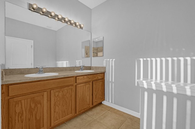 bathroom with vanity, tile patterned floors, and radiator