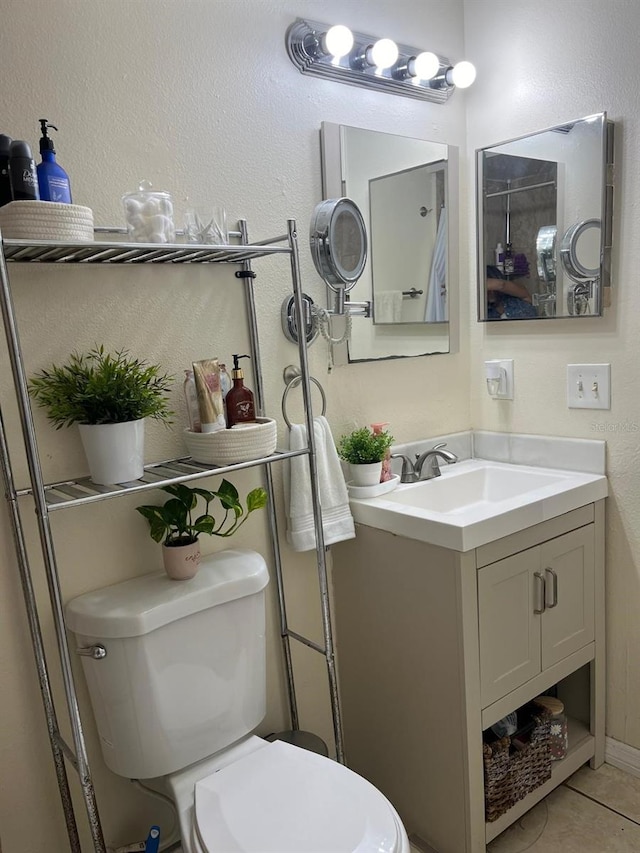 bathroom with tile patterned floors, vanity, and toilet