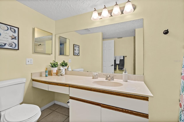 bathroom with tile patterned flooring, vanity, toilet, and a textured ceiling