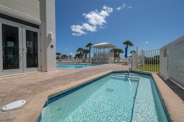 view of pool featuring french doors and a patio