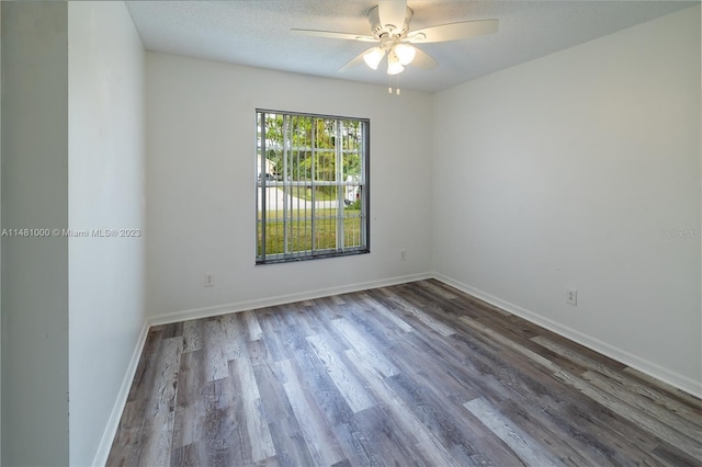 spare room with ceiling fan, hardwood / wood-style floors, and a textured ceiling