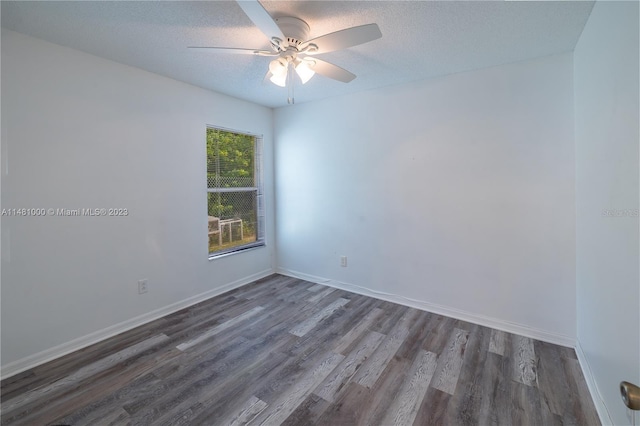 empty room with ceiling fan, dark hardwood / wood-style flooring, and a textured ceiling