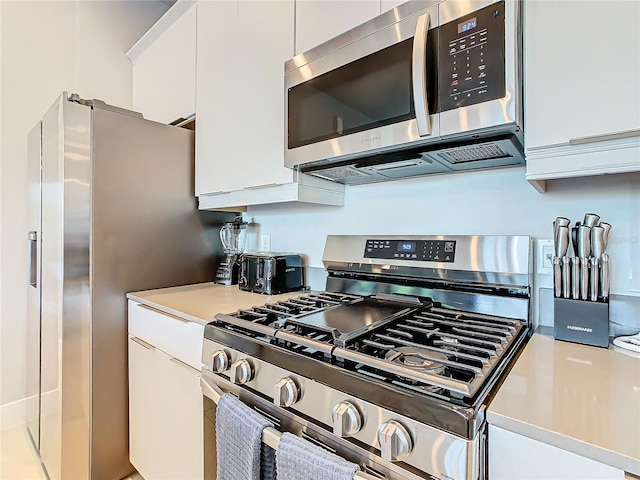 kitchen featuring white cabinets and appliances with stainless steel finishes