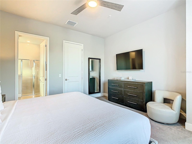 bedroom with ensuite bathroom, ceiling fan, and light colored carpet