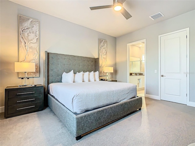 bedroom featuring carpet floors, ensuite bathroom, and ceiling fan