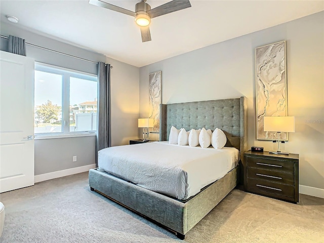 bedroom with ceiling fan and light carpet