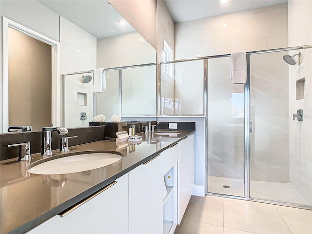 bathroom featuring tile patterned floors, vanity, and walk in shower