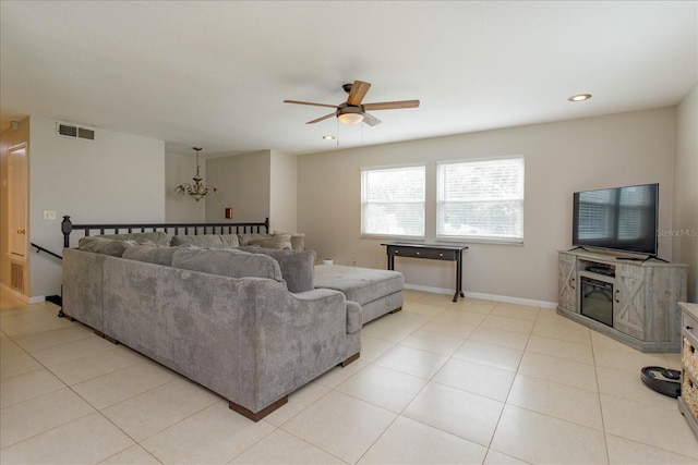 living room with light tile patterned floors, recessed lighting, visible vents, baseboards, and ceiling fan with notable chandelier