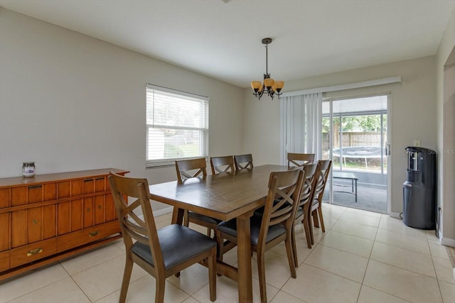 dining room featuring light tile patterned flooring and an inviting chandelier