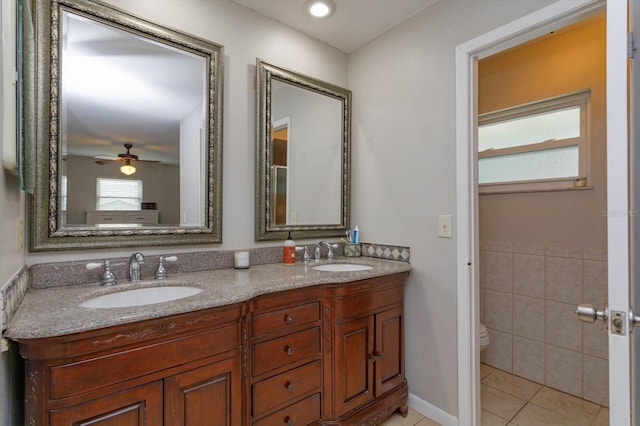 bathroom with toilet, vanity, tile patterned floors, and ceiling fan