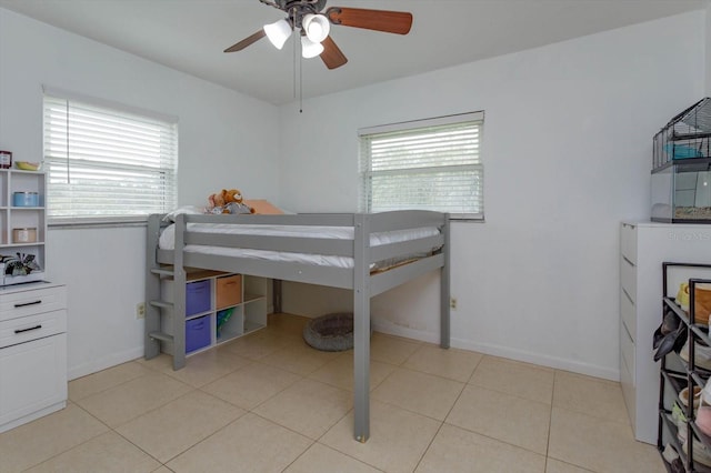 tiled bedroom with multiple windows and ceiling fan