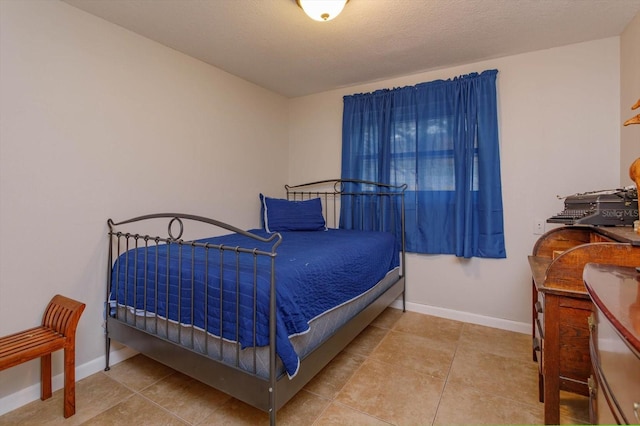 tiled bedroom featuring a textured ceiling