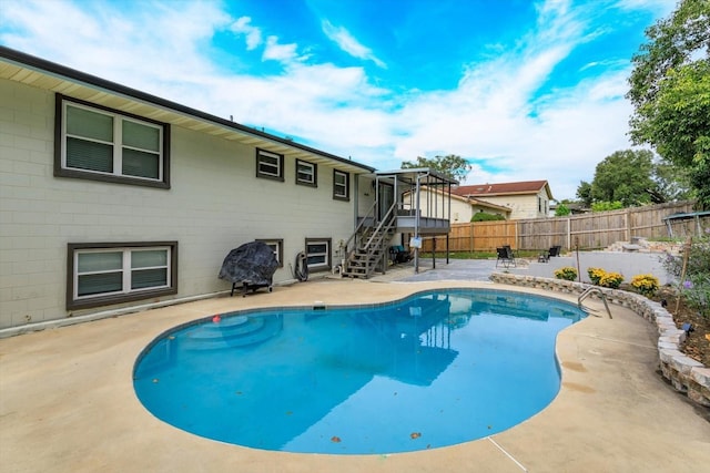 view of swimming pool with a patio area