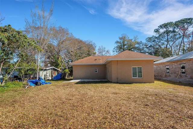 rear view of property with a yard