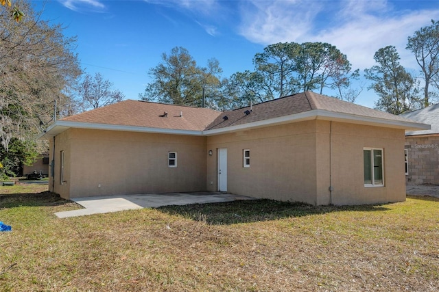 back of house with a yard and a patio area