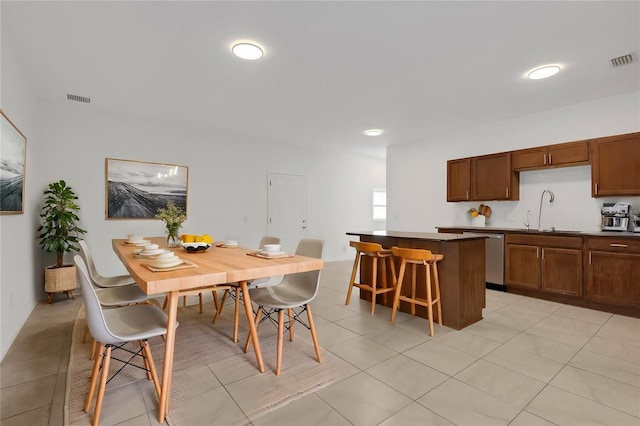 tiled dining room featuring sink