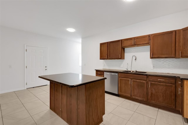 kitchen with sink, light tile patterned floors, dishwasher, and a kitchen island