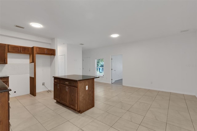 kitchen with a center island and light tile patterned flooring