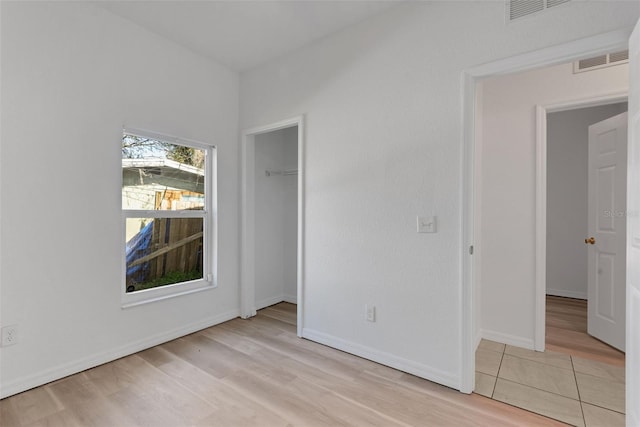 empty room with light hardwood / wood-style flooring