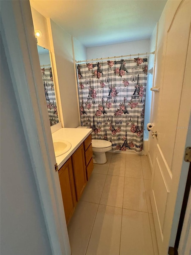 full bathroom with tile patterned floors, vanity, toilet, and shower / tub combo with curtain