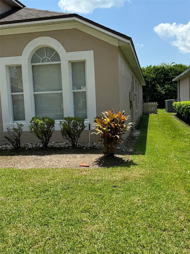 view of property exterior featuring a yard and central AC unit