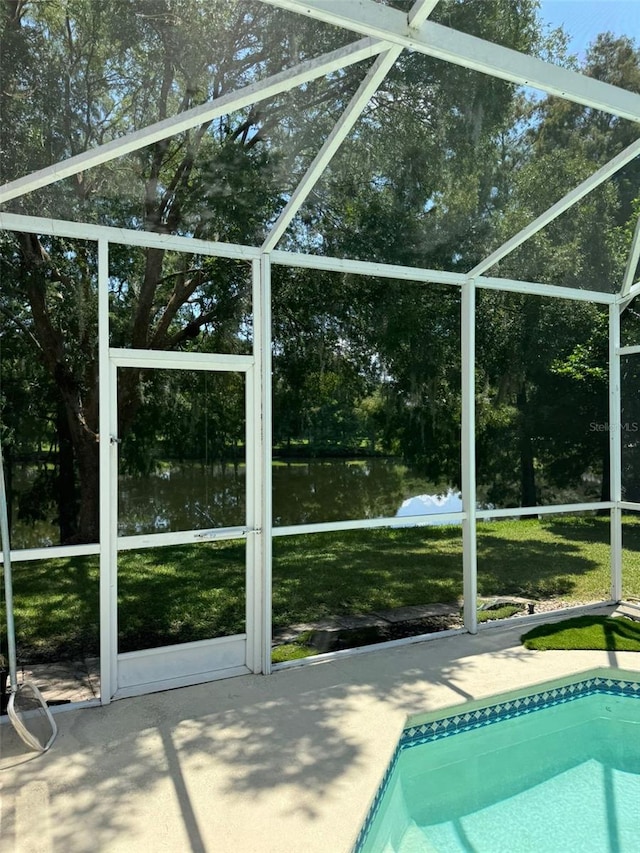 view of swimming pool with glass enclosure and a patio area