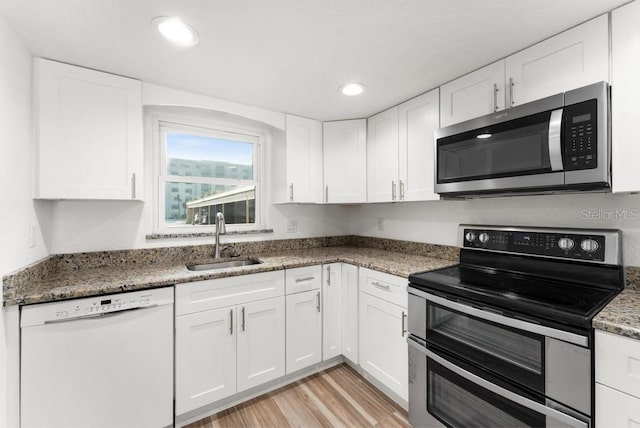 kitchen featuring sink, white cabinetry, and stainless steel appliances