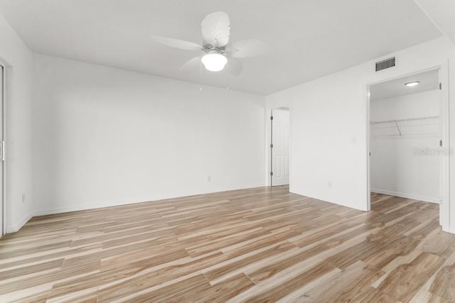 spare room featuring ceiling fan and light hardwood / wood-style flooring