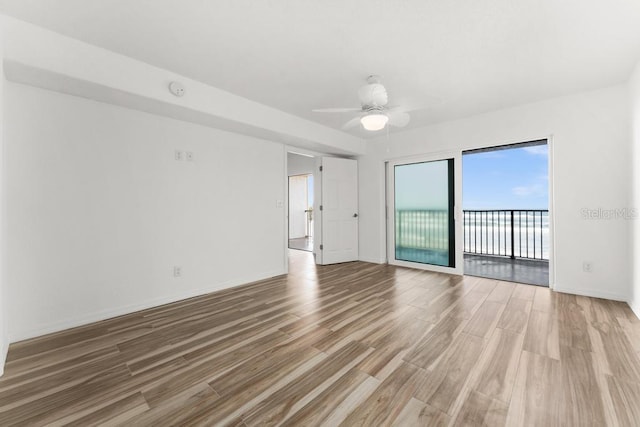 empty room with hardwood / wood-style flooring and ceiling fan