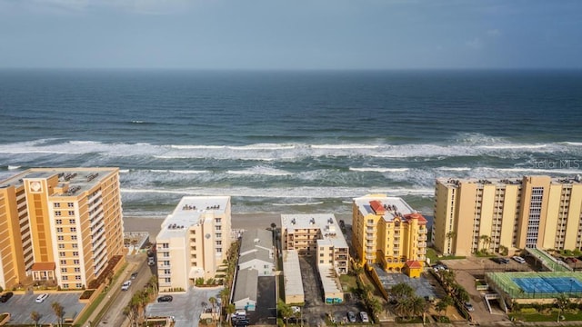 drone / aerial view featuring a water view and a beach view