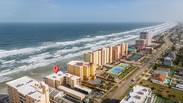 birds eye view of property featuring a water view and a beach view