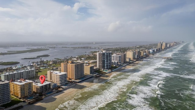 drone / aerial view featuring a beach view and a water view