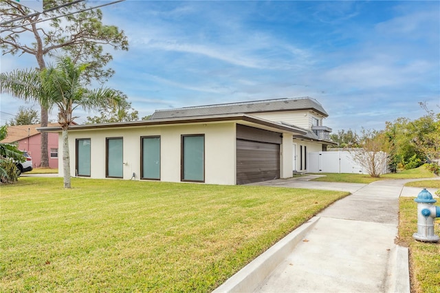 view of home's exterior with a lawn and a garage