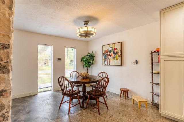 dining room with a textured ceiling