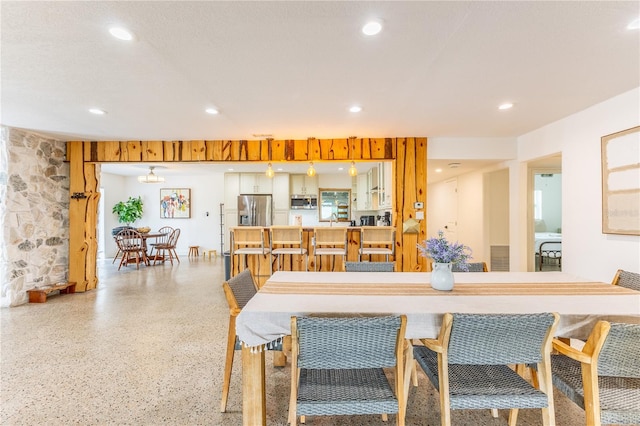 dining space with sink and a textured ceiling