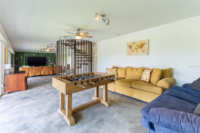 game room with a textured ceiling and ceiling fan