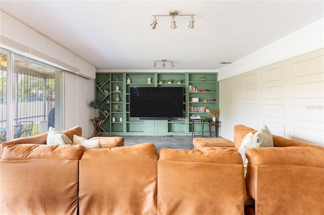 living room featuring a textured ceiling and rail lighting